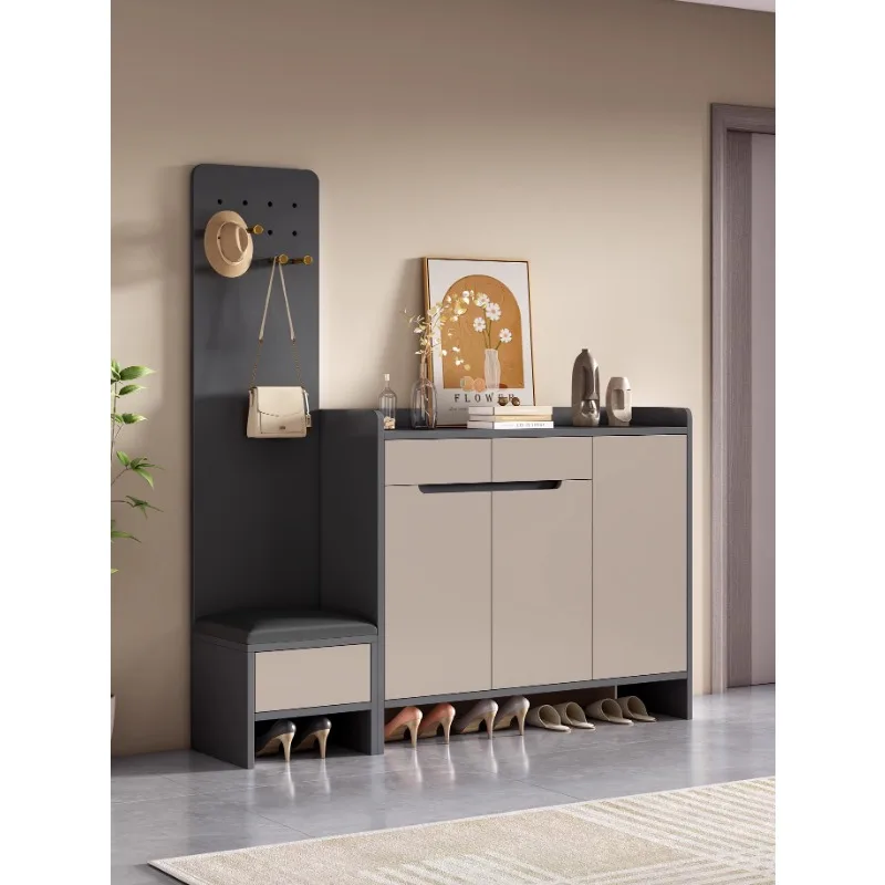 Modern and minimalist solid wood shoe cabinet at the entrance of the household, with shoe changing stools,