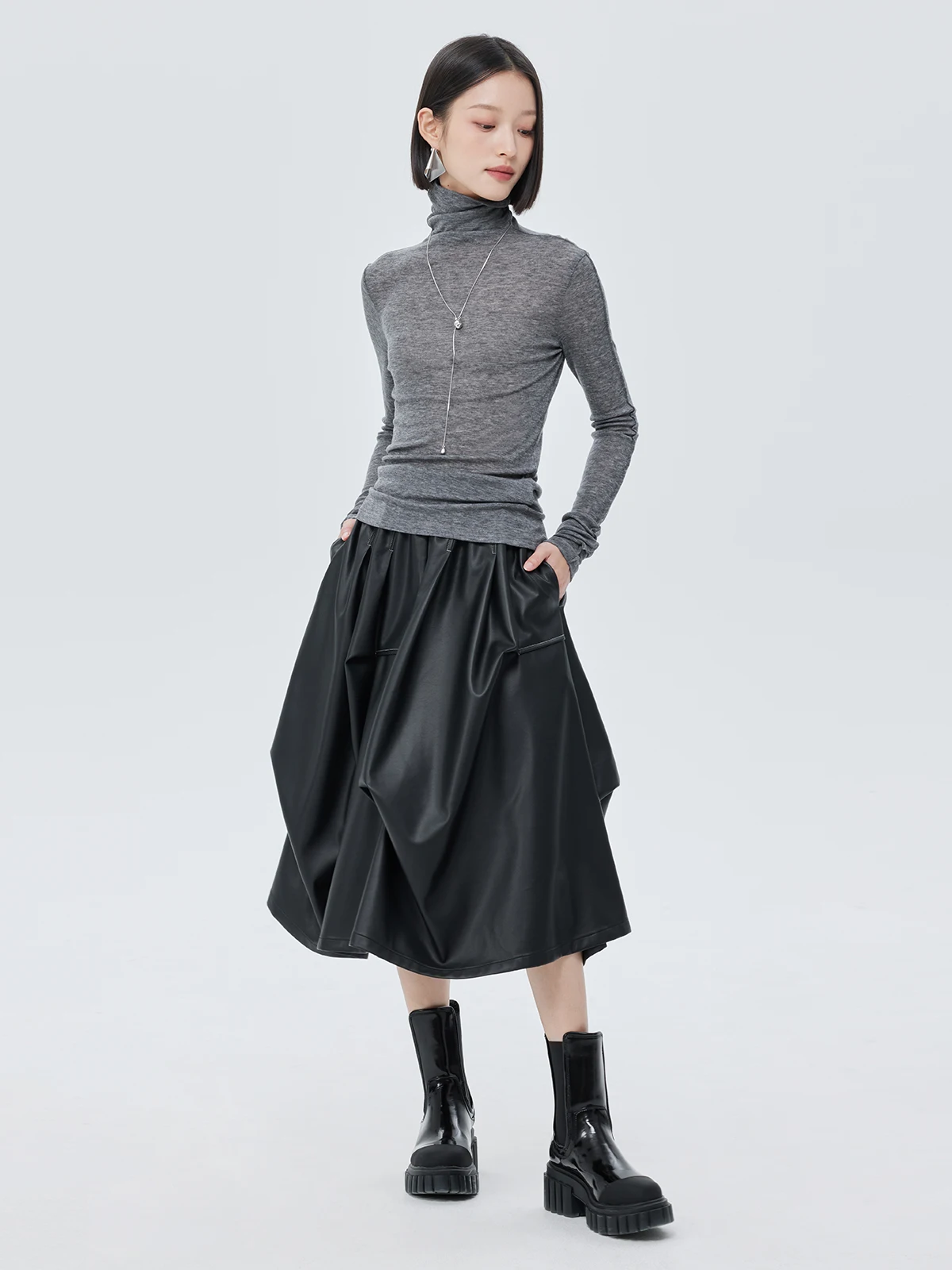 Nowa damska spódnica na jesień i zimę, czarna, asymetryczna, o średniej długości, elastyczna, z wysokim stanem, ze skóry ekologicznej (PU).