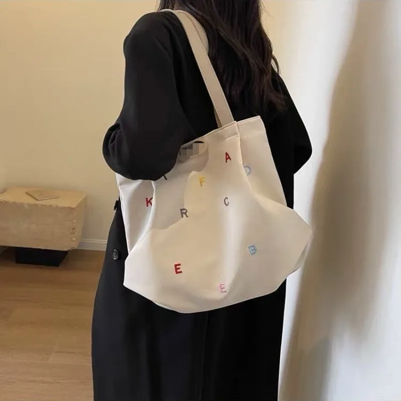 

2026 Hot Selling Large Capacity Casual Embroidered Letter Tote Bag, Small Fresh Student Canvas Shoulder Tote Bag Handbag