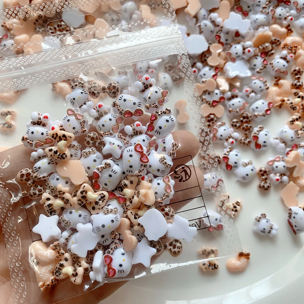 20pcs น่ารักเสือดาวแว่นตากันแดด Hello Kitty เล็บ Charms,ผสมเสือดาวพิมพ์ 3D ริบบิ้นโบว์อุปกรณ์เสริมการ์ตูนตกแต่งเล็บ