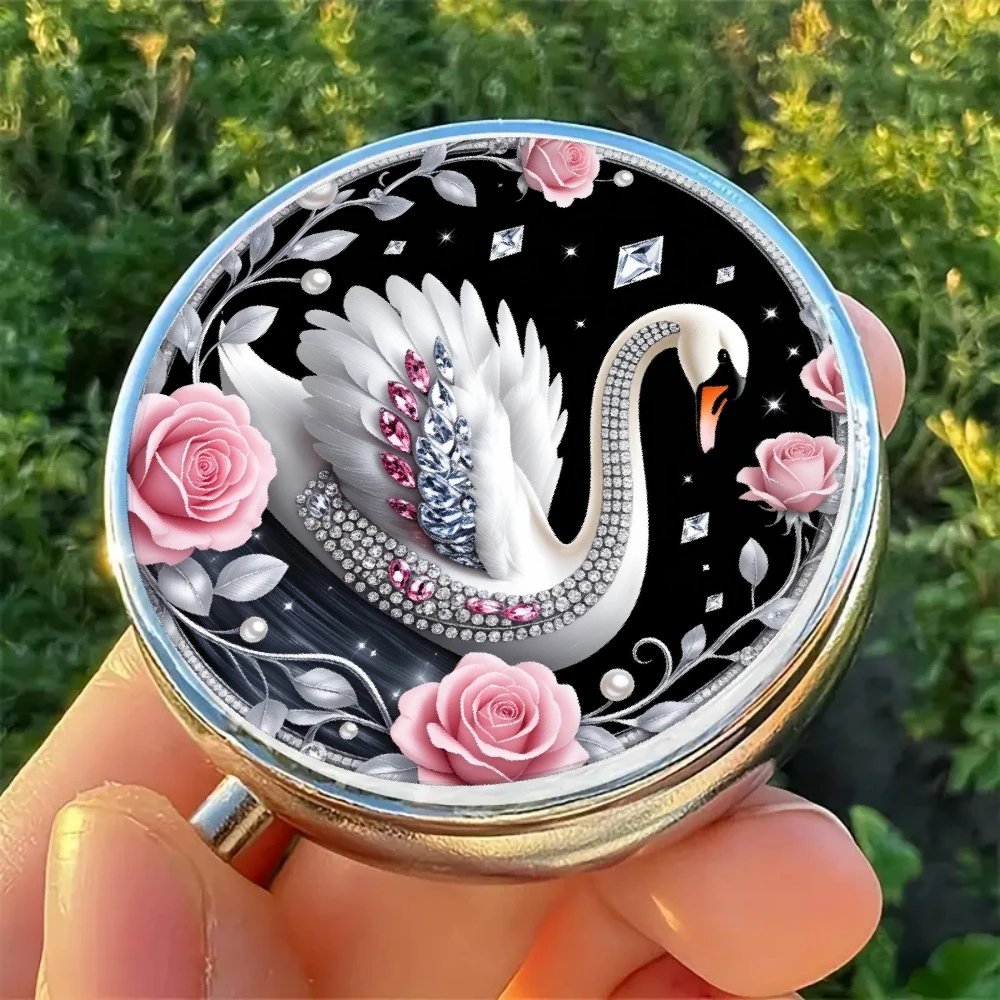A portable pill box with a swan and rose design, featuring three compartments, in pink color, and featuring a stylish plain pattern, making it a useful gift for anyone