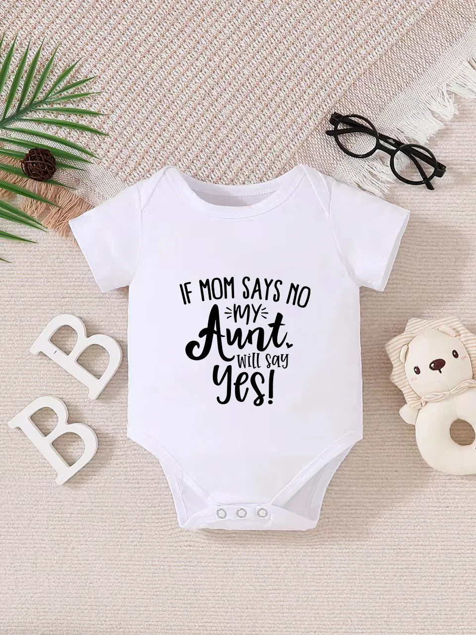Playful letter-printed baby short-sleeve triangle bodysuit. Button closure for easy dressing, machine washable
