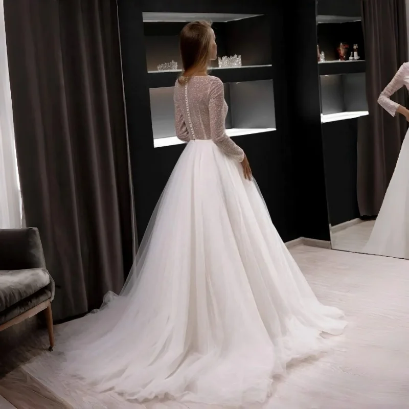 Minimalist Two Piece Bridal Gown Sparkle Illusion Bodice High Round Neck Long Sleeves Pearl Button Back Tulle A-Line With Train