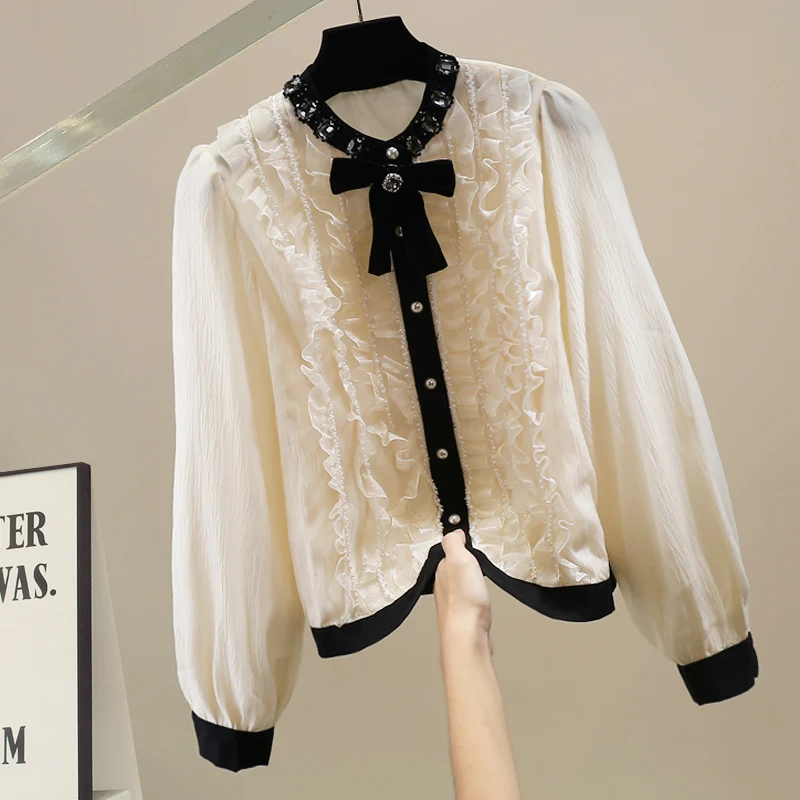 

Модный женский топ с длинными рукавами, богато декорированный узлами, универсальный и стильный дизайн, трендовая модель.