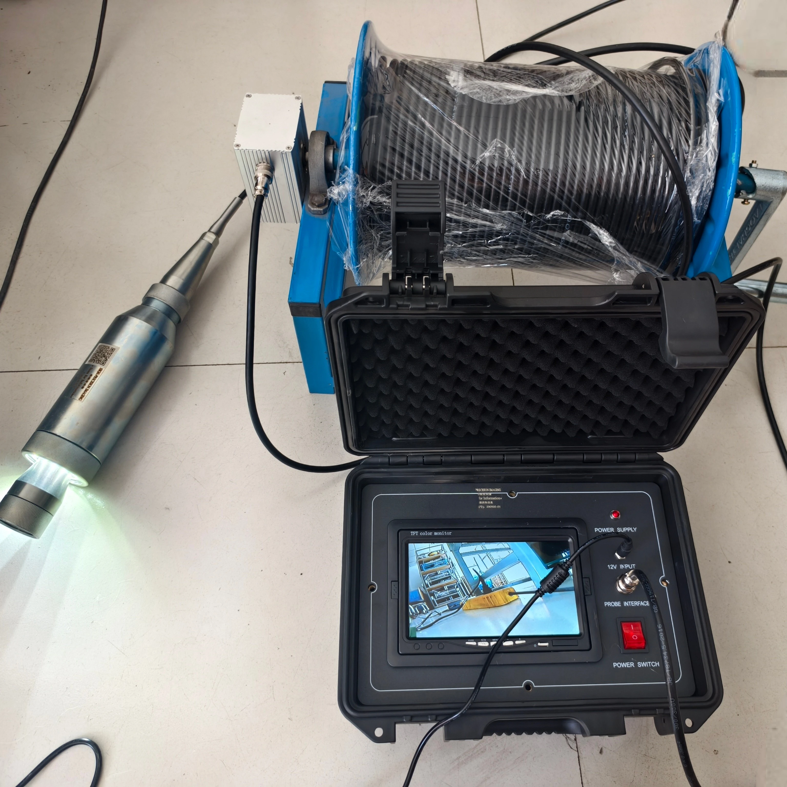 

Downhole Camera with a Counting Pulley Depth Recording and Rotating Camera