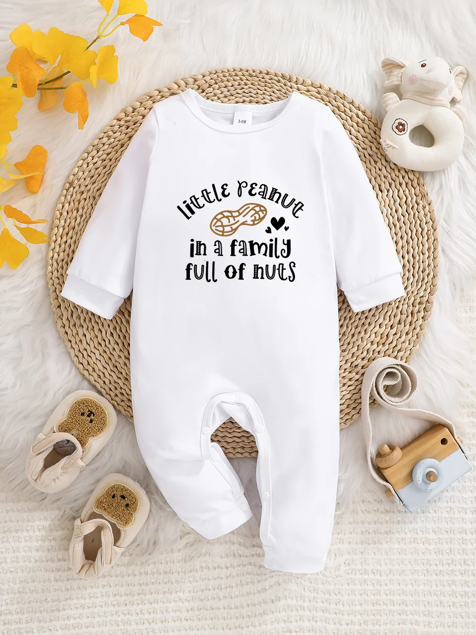 A baby long-sleeved onesie with interesting letter prints. It features a buttoned design for easy putting on and taking off
