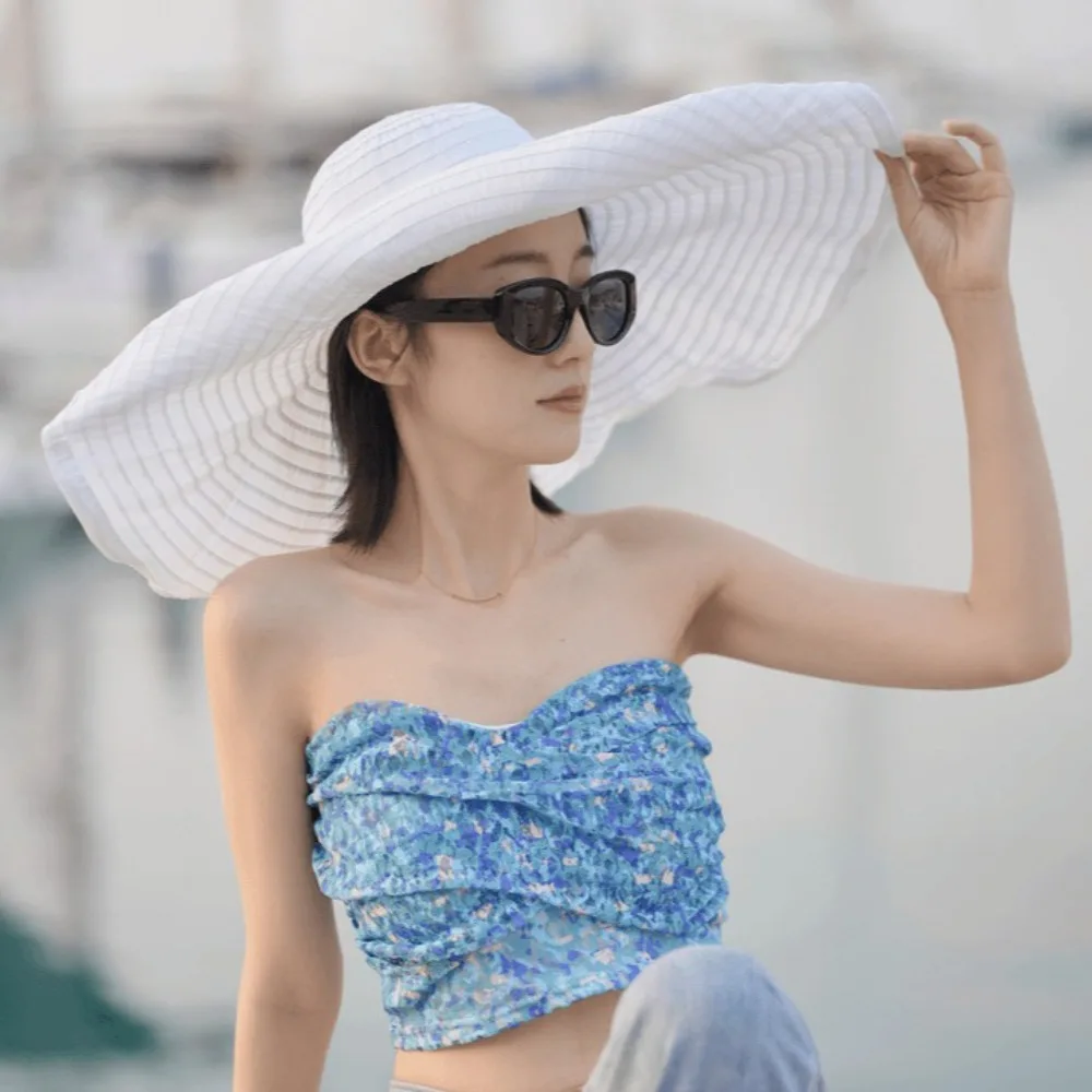قبعة قابلة للتعبئة بعقدة على شكل فيونكة قابلة للتشكيل ذات حافة واسعة واقية من الشمس وقابلة للطي من البلاستيك قبعة دلو للأشعة فوق البنفسجية ومضادة للتنفس للنساء قبعة الشمس للشاطئ