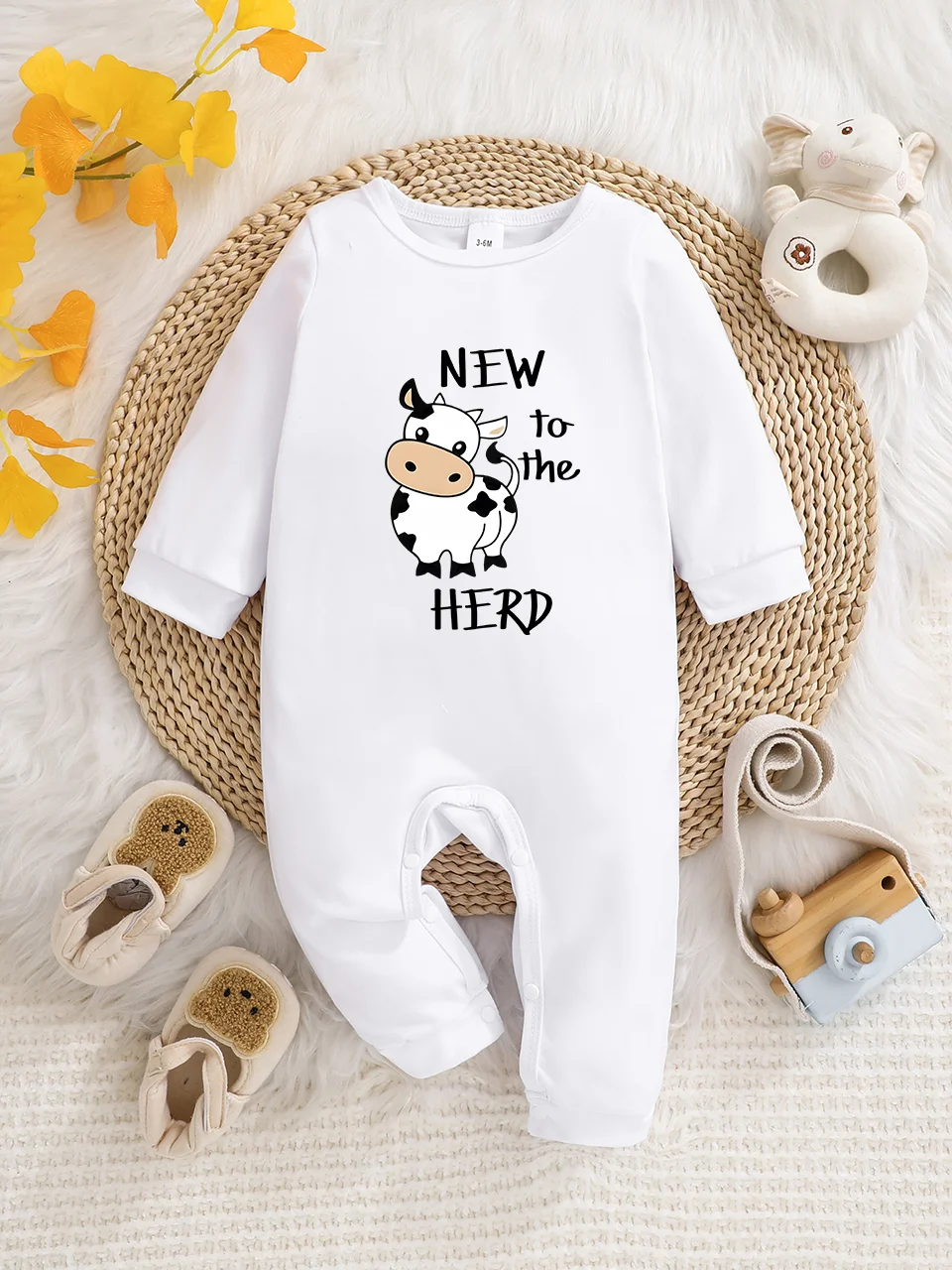 A baby long-sleeved onesie with interesting letter prints. It features a buttoned design for easy putting on and taking off