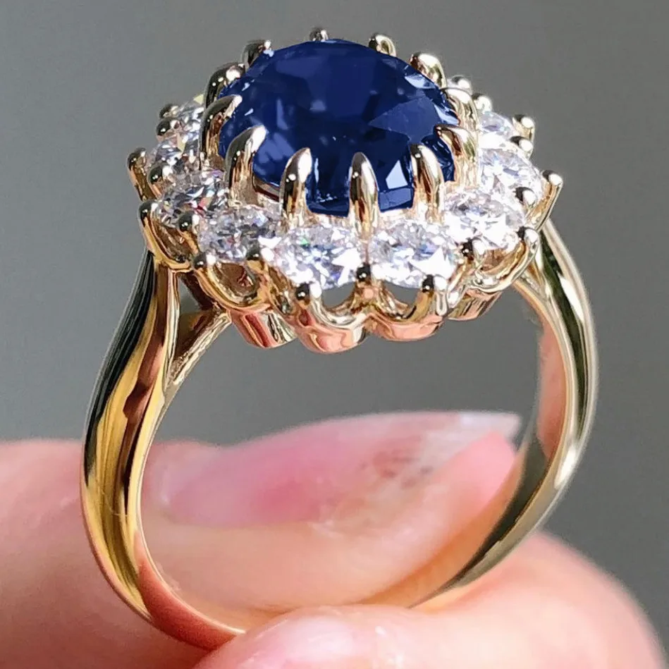 Exquisiter goldfarbener ovaler Damenring mit blauem Zirkon eingelegt, klassische Mode, Verlobung, Ehering, Damenschmuck