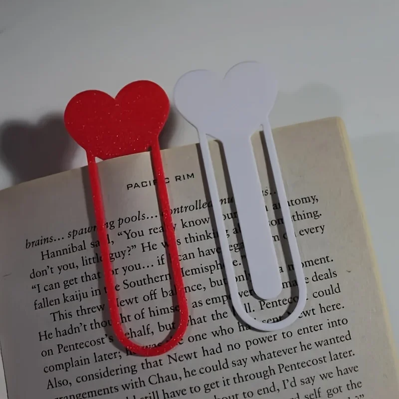 Heart Art Bookmarks - Featuring red and black glitter, these sturdy plastic page markers are perfect for book lovers and make great gifts for friends. They have a lively design and are lightweight.
