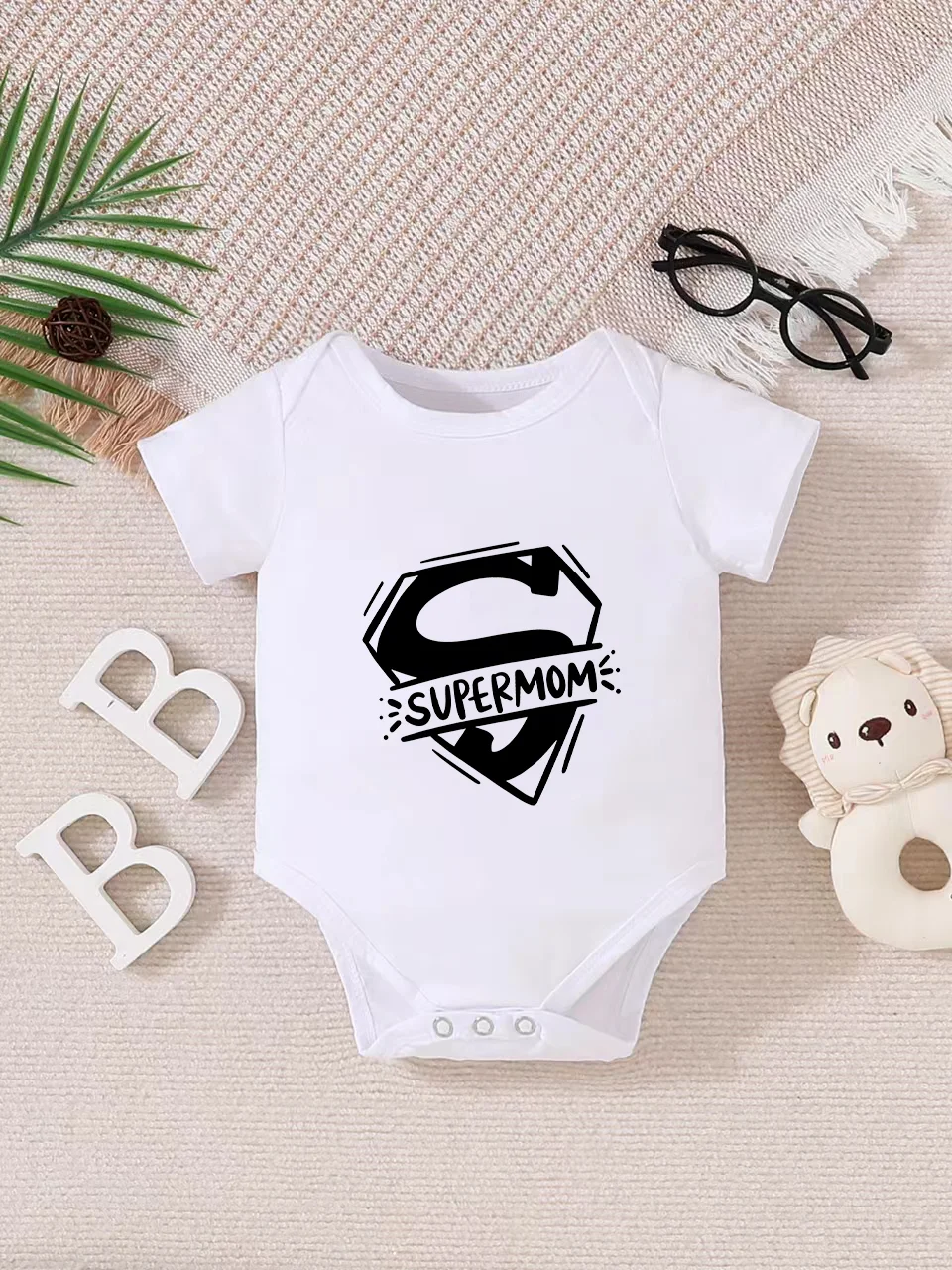 Playful letter-printed baby short-sleeve triangle bodysuit. Button closure for easy dressing, machine washable