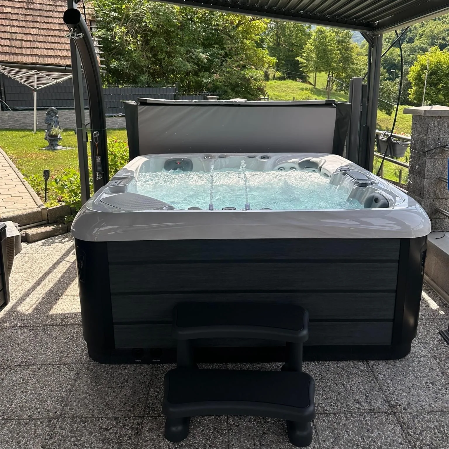 Five-person acrylic outdoor hot tub, suitable for homes and gardens, featuring three seats and two loungers