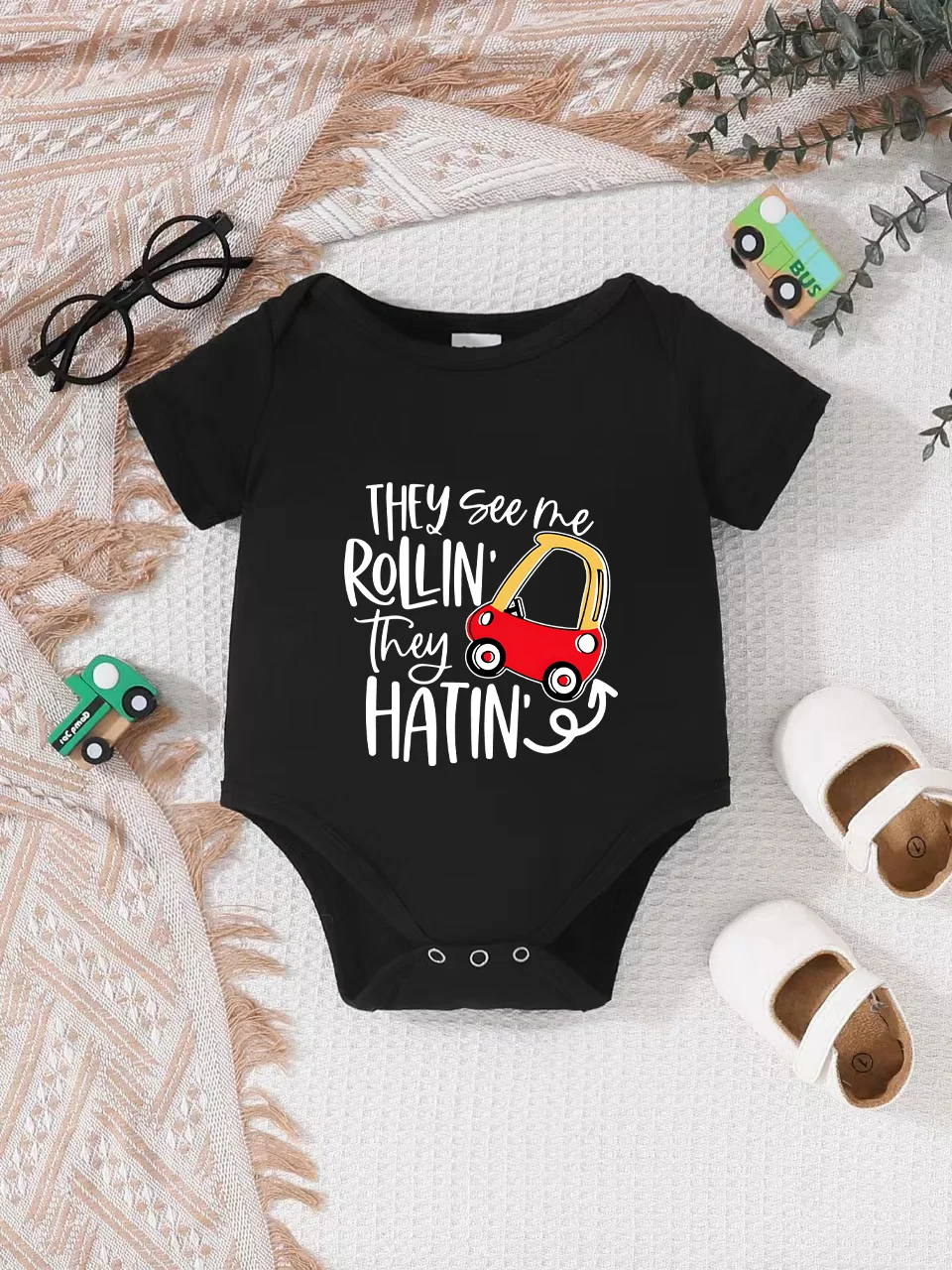 Playful letter-printed baby short-sleeve triangle bodysuit. Button closure for easy dressing, machine washable