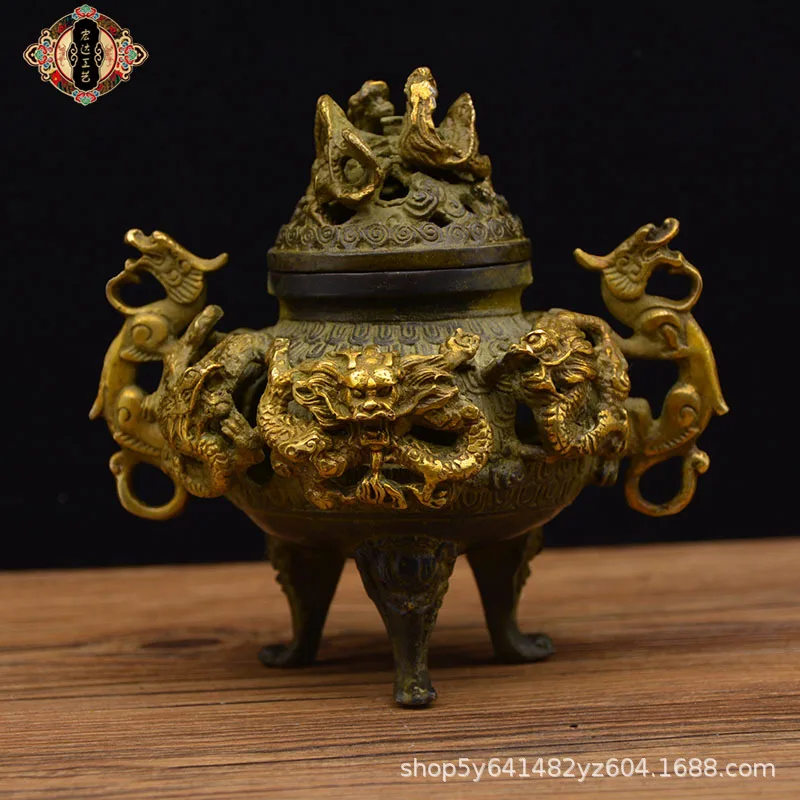 Copper incense burner with gilded nine-dragon design, a decorative piece for display at a street market