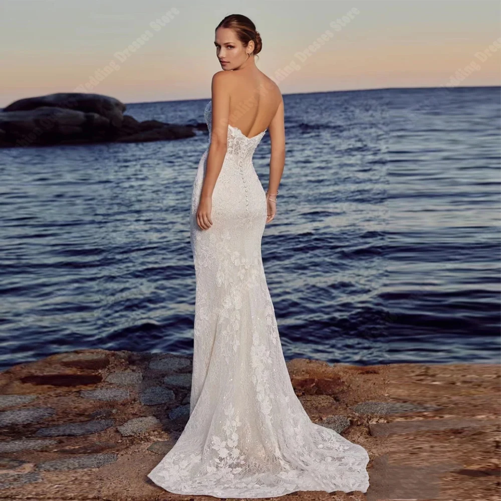 Lussuosi abiti da sposa con applicazioni di pizzo Vintage eleganti abiti da sposa senza schienale moderni con strascico Sexy senza maniche sirena 2024