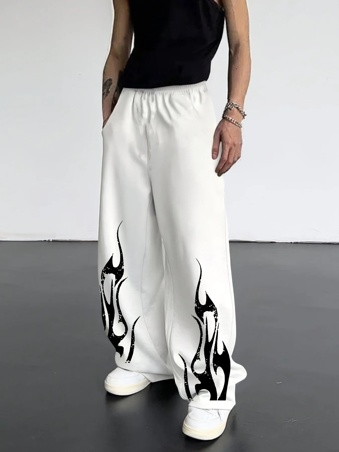 Men's Loose-fit, Straight-leg Streetwear Joggers Featuring A Retro Black Flame Pattern and An Elastic Waistband.