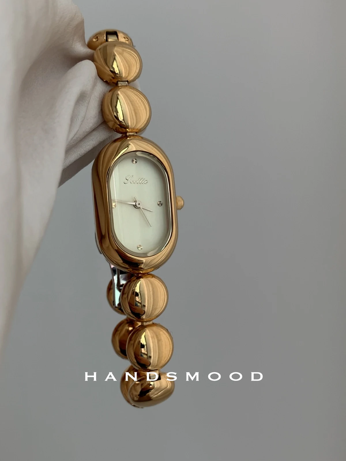 Elegant women's wristwatch with a stylish strap, trendy and individualistic design, sophisticated and fashionable quartz watch.