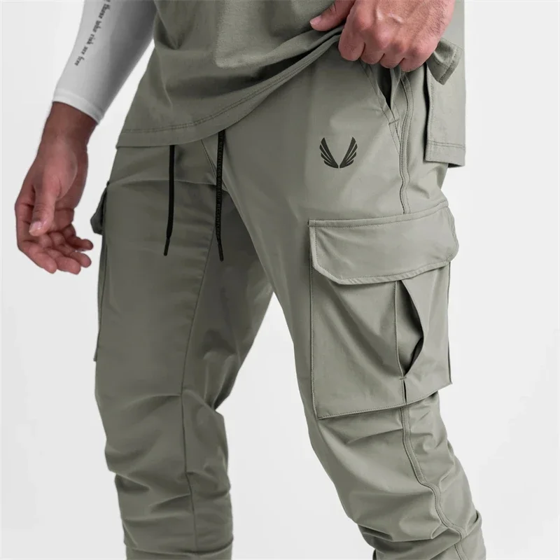 Pantalones Cargo con bolsillo para hombre, mallas elásticas delgadas de secado rápido, pantalones de chándal de entrenamiento para correr,