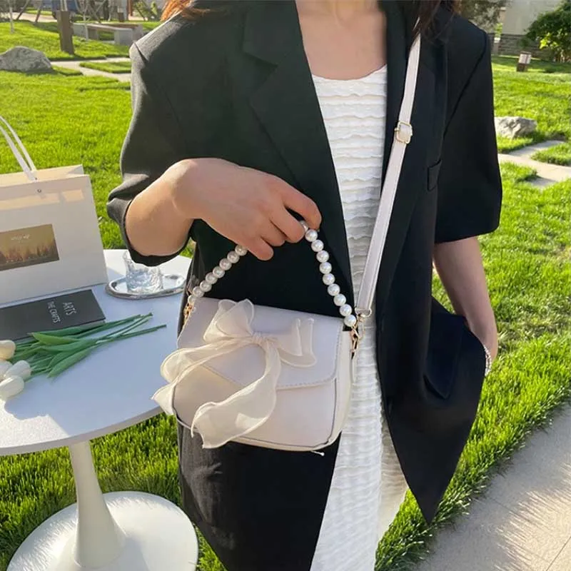 حقيبة كتف السيدات السوداء الكورية القوس عقدة قمة الموضة مقبض حقيبة المرأة قماش كبير الإبط حقيبة 2025 مصمم حقائب اليد الجديدة bolsas