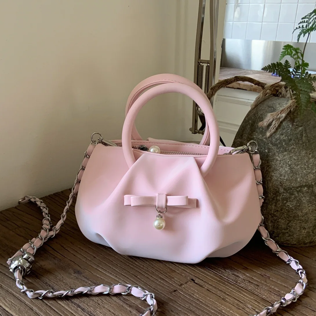 

Маленькая женская сумка через плечо из веганской кожи с верхней ручкой и милым бантом для стильного хранения