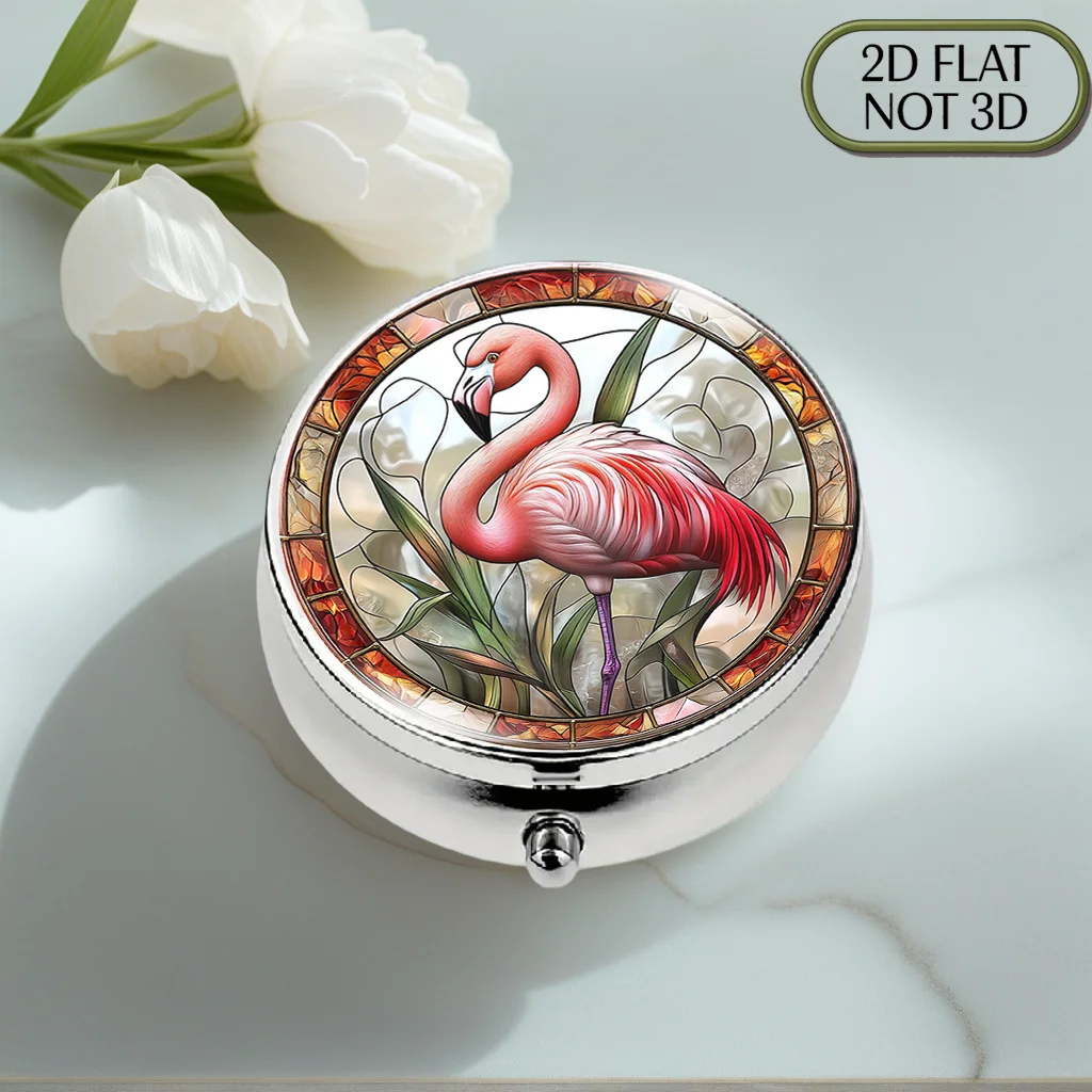 A flat, portable, round metal pill box, adorned with a vibrant stained glass flamingo pattern, is a stylish and convenient way to store your supplements and medication. It is the perfect choice for organizing vitamins, keeping small items safe, or as a th