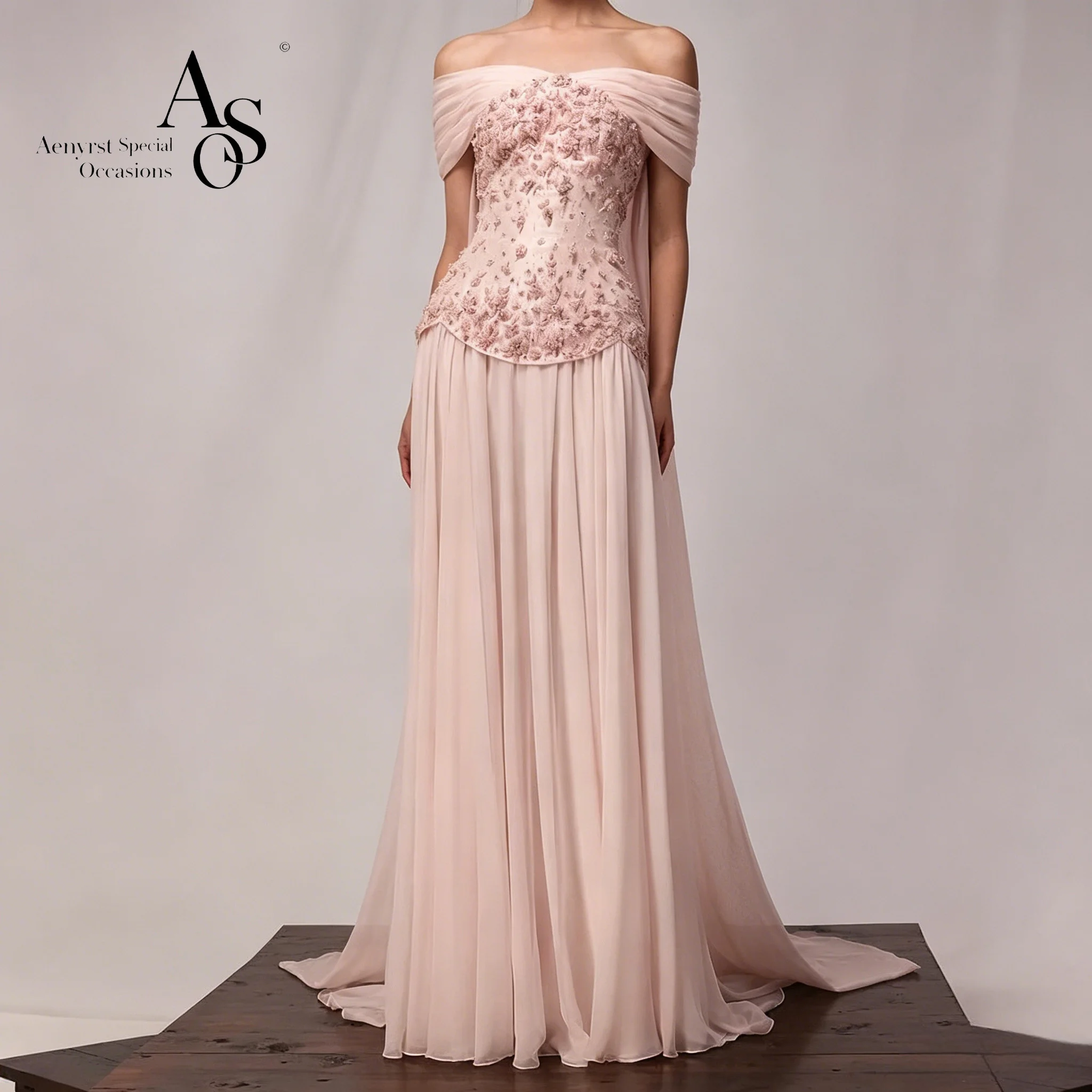 

An elegant pink strapless off-the-shoulder dress adorns a formal evening gown, featuring draped details.