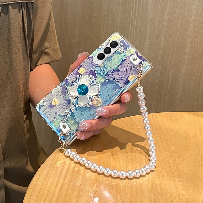 

Luxury Rhinestone Flower Phone Cover For Samsung Galaxy Z Fold 5 4 3 Portable Pearl Wrist Chain Watercolor Floral Blue Ray Case