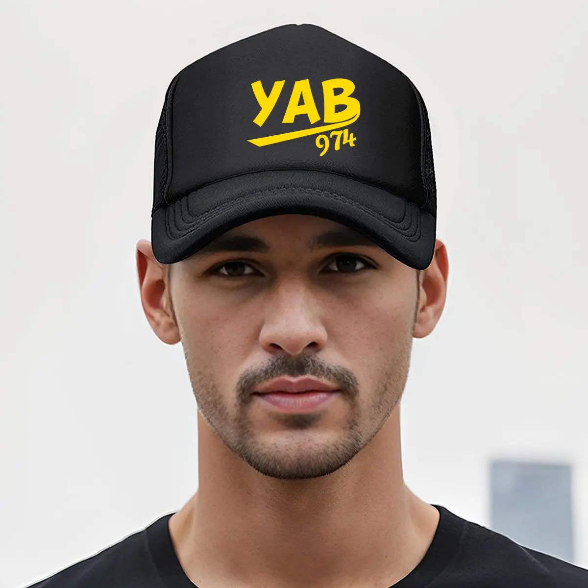 YAB 974 in berretto da baseball in rete con tipografia gialla audace