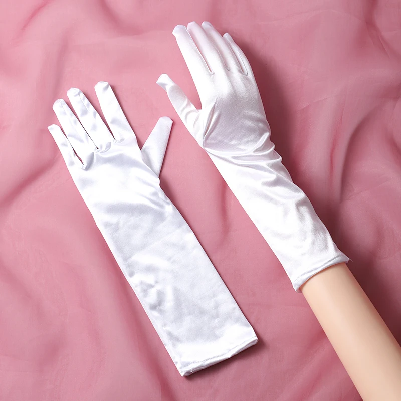 The bride's accessory is a pair of white minimalist split finger mid length gloves suitable for women's wedding parties