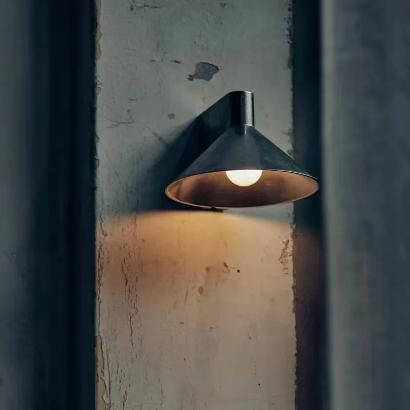 Modern outdoor wall lamp with black metal lampshade and brass LED light source, used for hotel and garden decoration