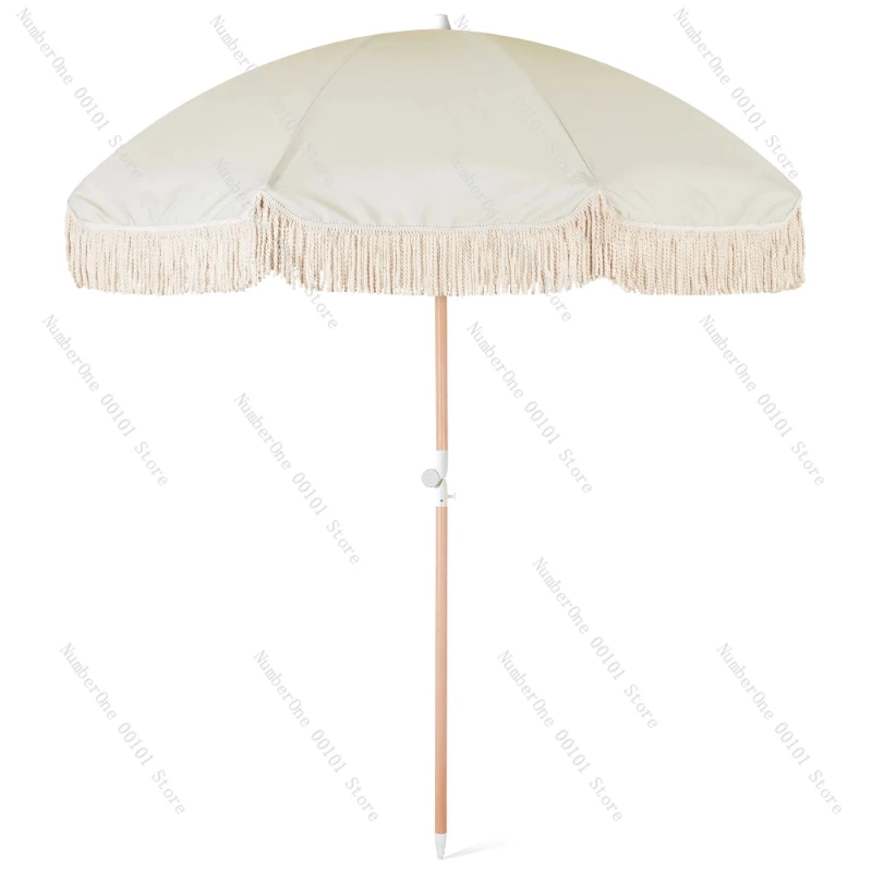 white beach umbrella with tassels