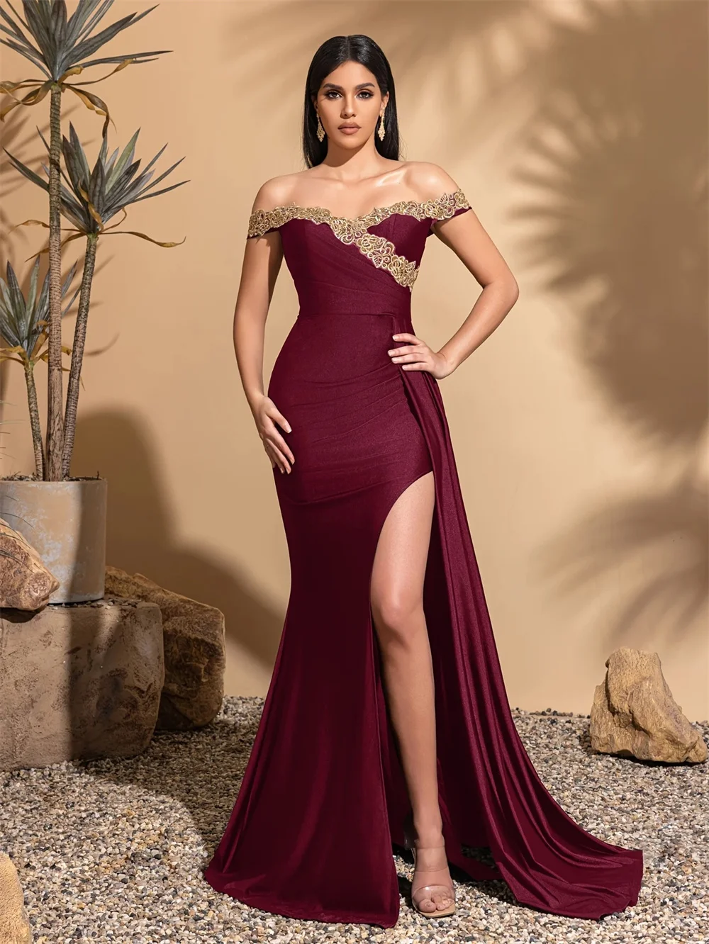 

Customized burgundy strapless floor-length gown with open back and front slit. The waist cincher flatters your figure and presen