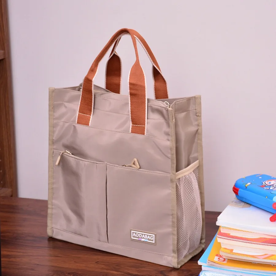 

【New style】Large-capacity primary school junior high school handbag student carrying books waterproof oxford cloth tutoring han