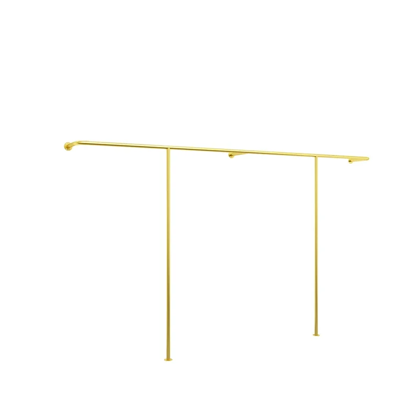 Simple golden clothing store display rack straight pole floor-to-ceiling women's clothing children's clothing hanging against th