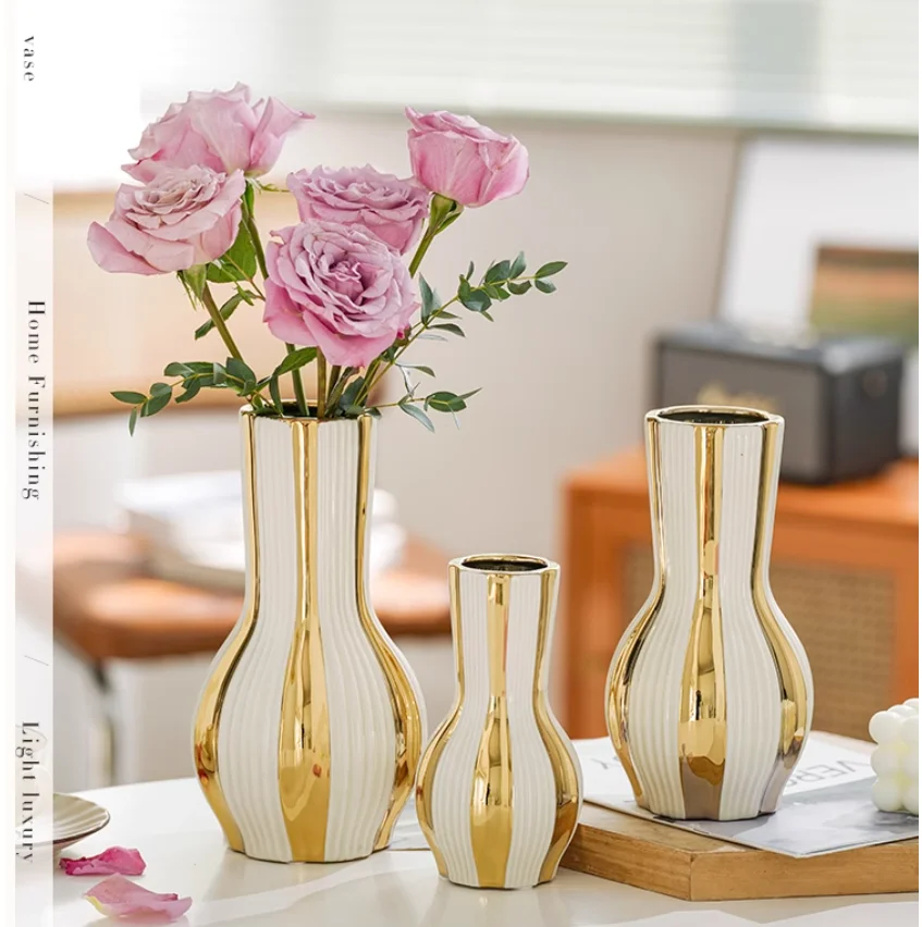 Advanced and minimalist gold painted ceramic vases, water-based rose flower arrangements, dining room, living room, soft floral