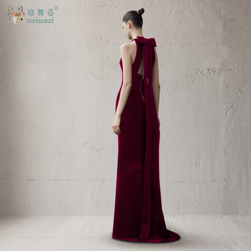 فستان سهرة بتصميم عصري برقبة معلقة بدون أكمام ذهبي مخملي وطول يصل إلى الأرض مع فيونكة بدون ظهر للمناسبات الرسمية