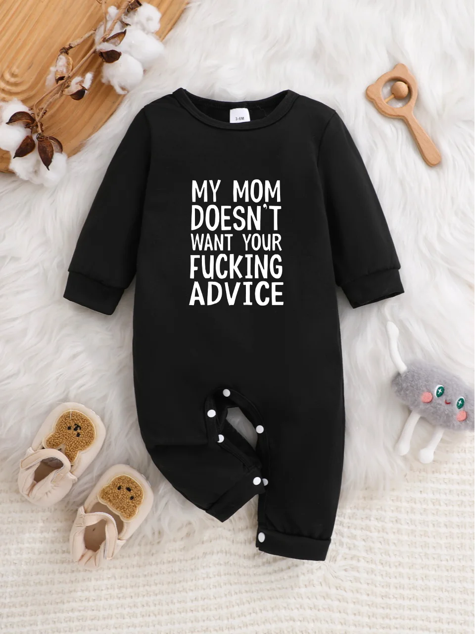A baby long-sleeved onesie with interesting letter prints. It features a buttoned design for easy putting on and taking off