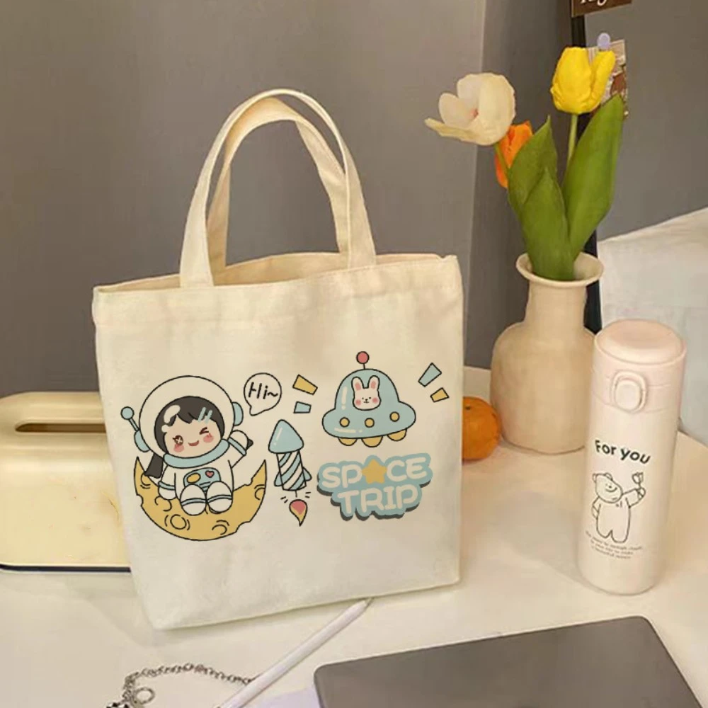 Bolso de mano de lona de dibujos animados de astronauta, bolsa de almacenamiento de gran capacidad, bolsa de almuerzo de viaje, moda