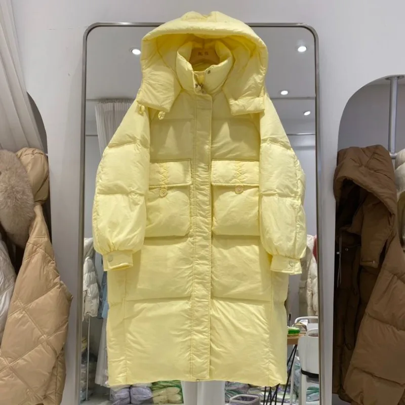Giacca da donna media e lunga sopra il ginocchio 2025 Nuova versione coreana Moda allentata ispessita con cappuccio Piumino d'anatra bianco Marea