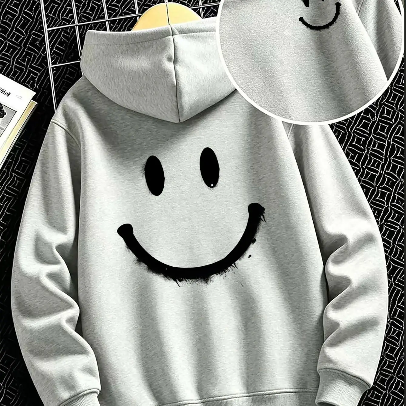 Boys' hoodie, loose and comfortable with a large smiley face print, featuring a shorter front and longer back design.