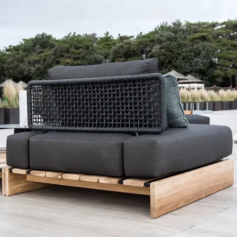Durable and Chic Outdoor Teak Sofa with Rattan Elements Designed to Withstand the Elements While Enhancing Your Outdoor Decor
