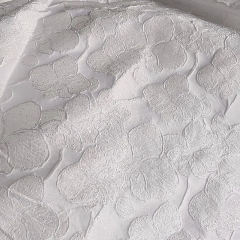 Embossed dark pattern white blue jacquard fabric with a textured for women's dress and evening wear
