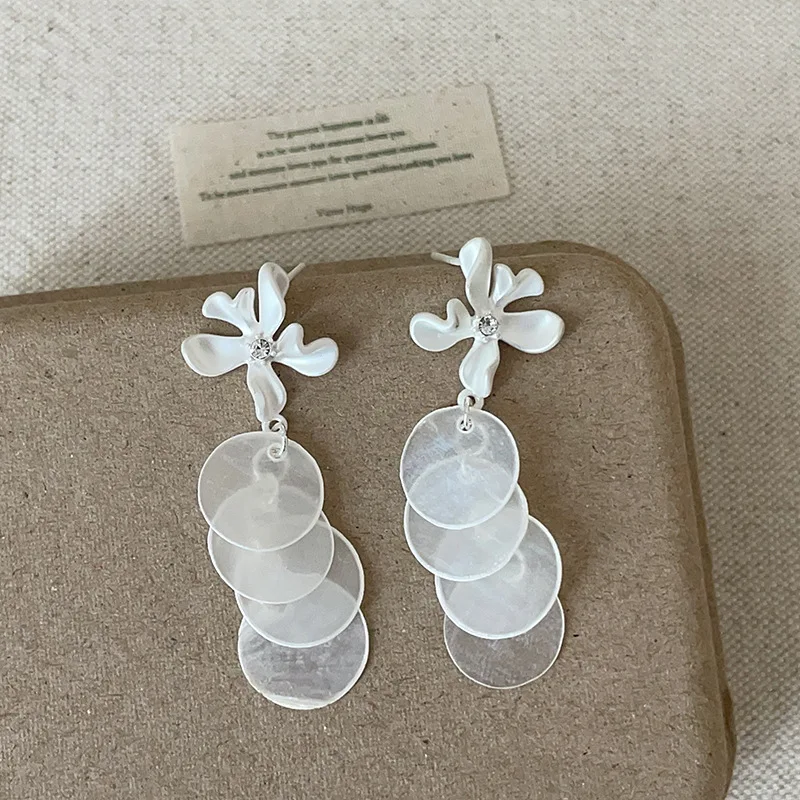 

Minar French White Color Round Shell Metallic Irregular Flower Petal Long Drop Earrings for Women Silver Plated Copper Jewellery