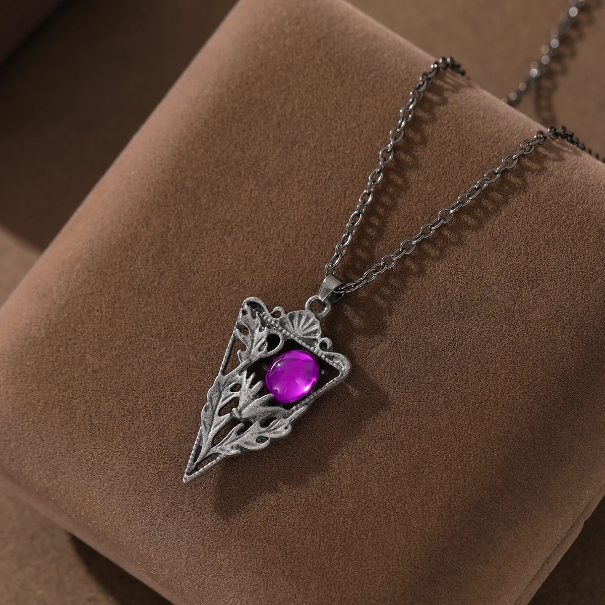 The retro-style triangular hollowed-out purple synthetic gemstone women's pendant necklace is suitable for daily wear.