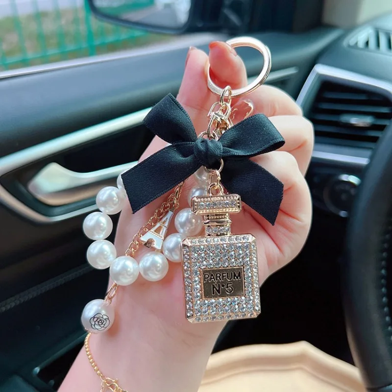 Alloy Diamond Inlaid Bow Shaped Perfume Bottle Key Chain Creative Pearl Chain Bag Pendant Exquisite Car Key Ring Accessories