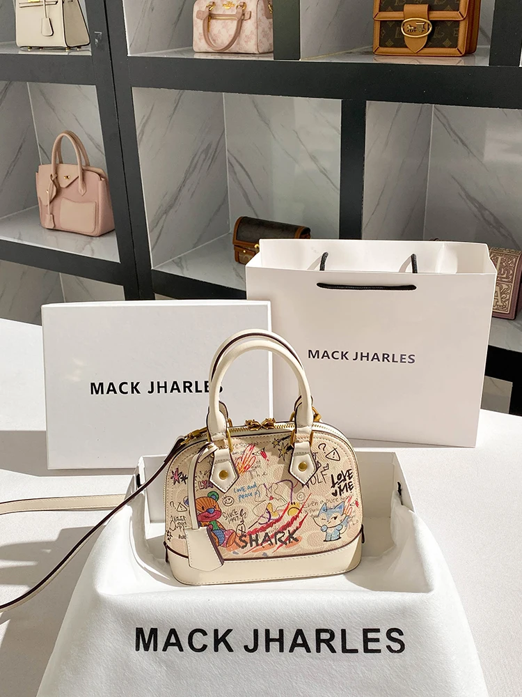 

Cute and Luxury Shell Bag with Charming Decoration Bear Graffiti and Pendant Women Stylish and Versatile Handheld Crossbody Bag