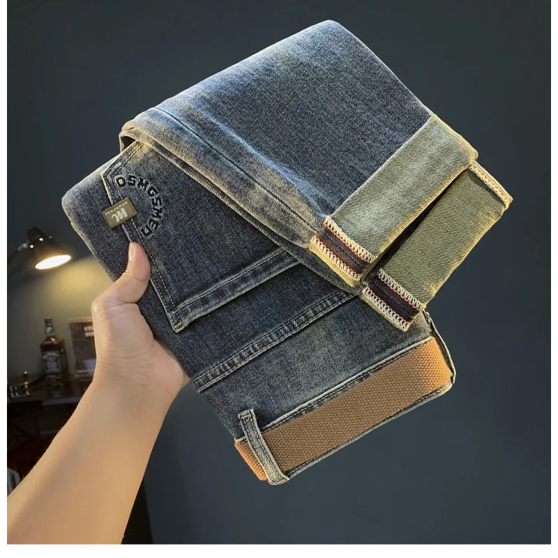 Luksusowe jeansy męskie na jesień i zimę, grube, elastyczne, w stylu retro, niebieskie, z wąską nogawką, lekko rozszerzane męskie spodnie.