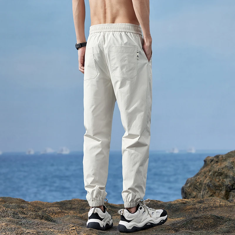 Pantalones de seda de hielo finos para hombre, pantalones deportivos de secado rápido, pantalones de trabajo ajustados con punta suelta, moda de verano, 2024