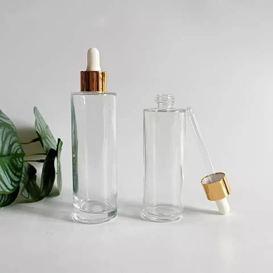 Wholesale 20-100ml Transparent Flat Shoulder Glass Essential Oil Serum Dropper Bottle With Gold Lid Skin Care Emulsion Container