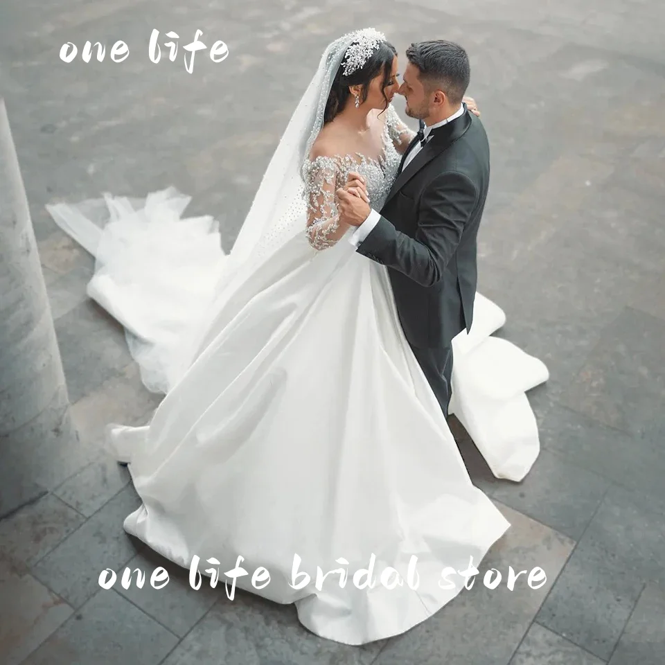 ชุดแต่งงานแบบบอลกาวน์ประดับลูกปัดหรูหราสไตล์ดูไบจาก Onelife รุ่นปรับแต่งได้ ปี 2025 คอซีทรูแบบเจ้าหญิง สำหรับเจ้าสาว ชุดเจ้าสาว Vestido De Novia
